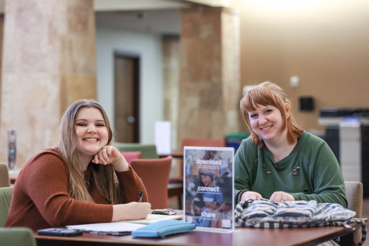 Two students study together at a table