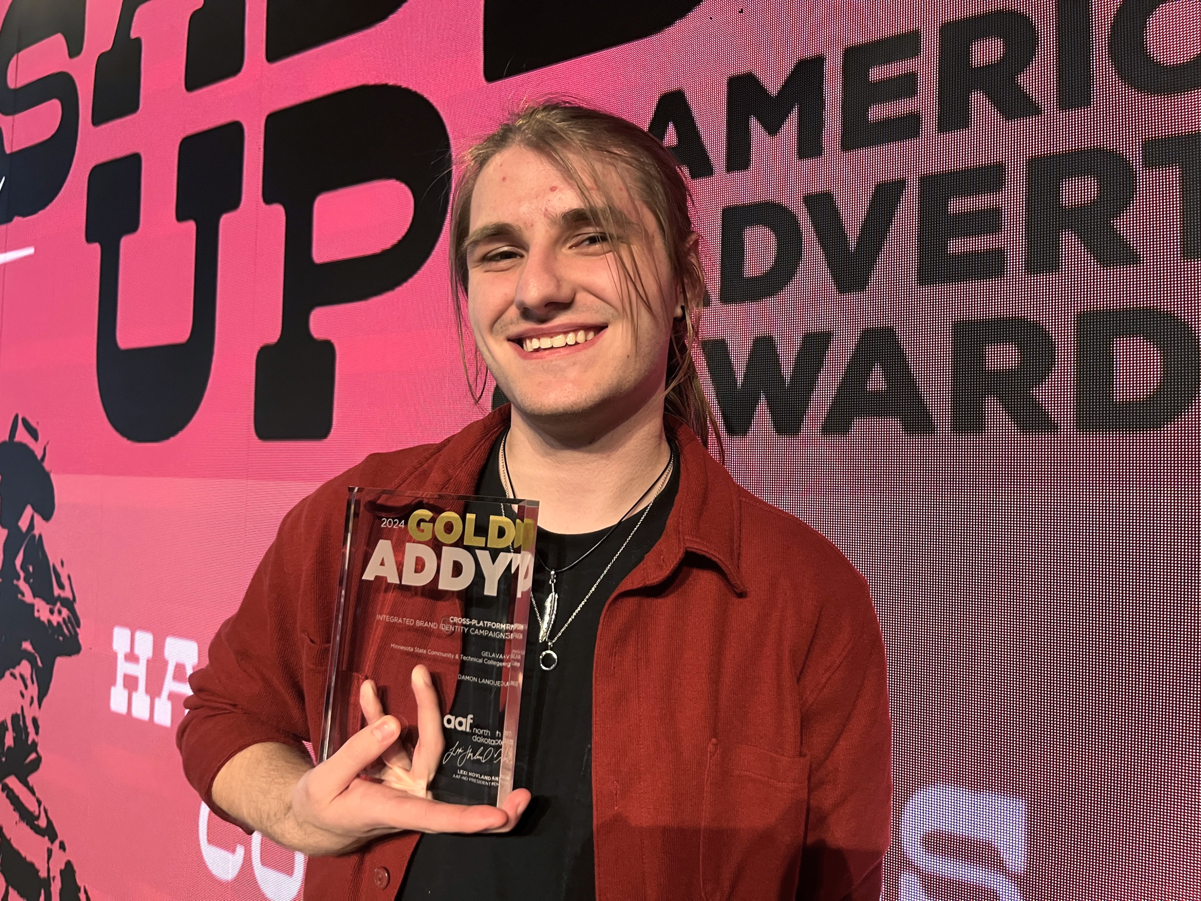 M State graphic design student Damon Lanoue, with his Gold Addy plaque.