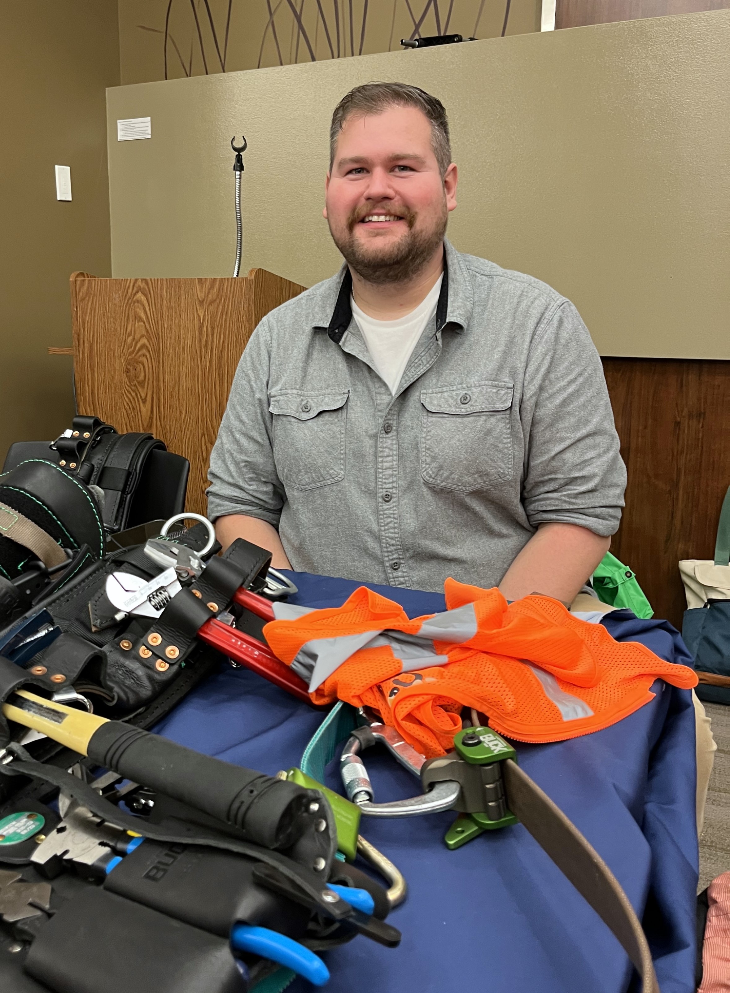 Logan Schrader of the Minnesota State Centers of Excellence shows lineworker gear during the career exploration portion of the Minnesota Works event