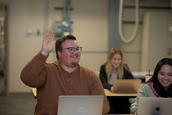 A student raises their hand in class