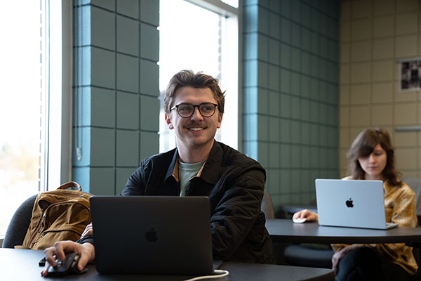 A student works at a laptop