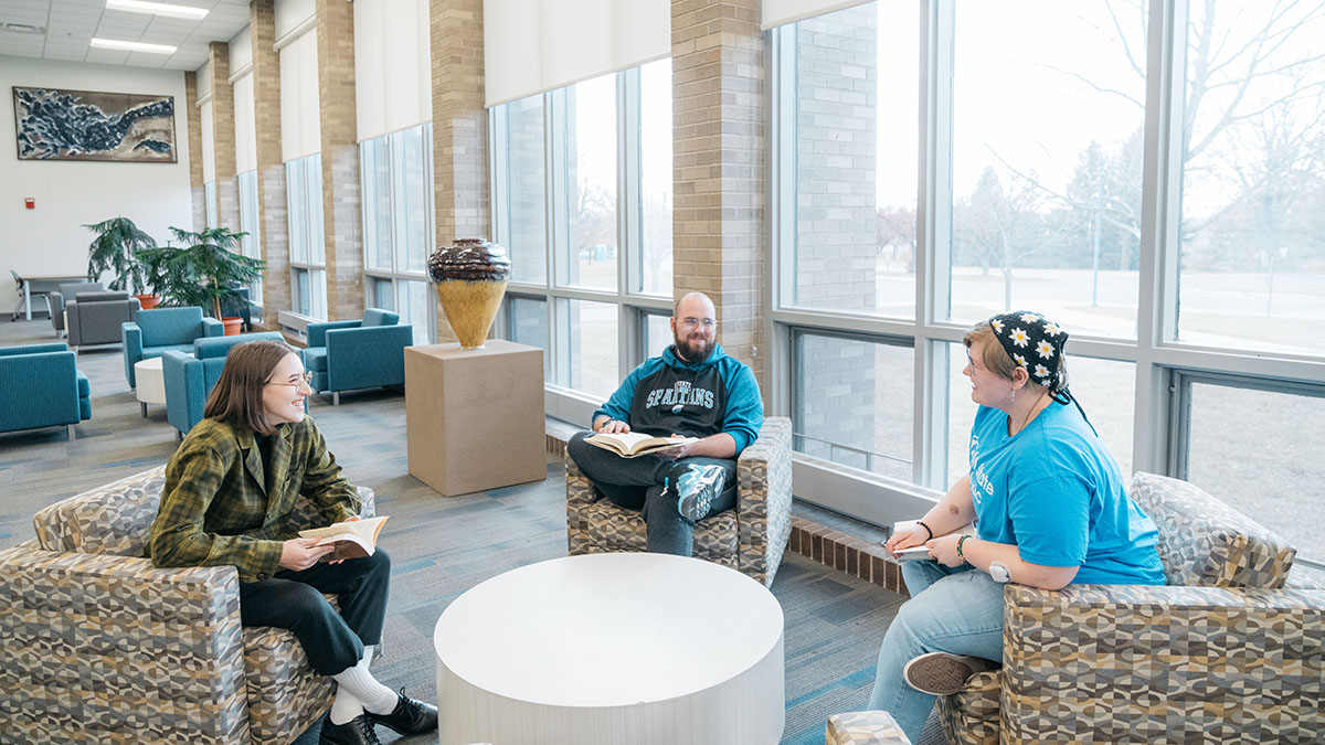 Three people in a lounge talk to each other at M State Fergus Falls