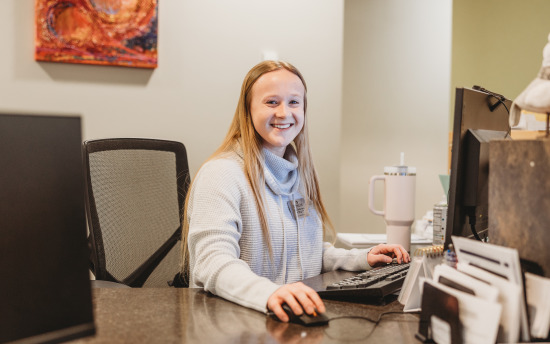 Photo of the front desk with a smiling face that greets you as you walk into camp us