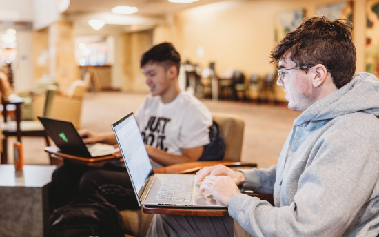 Photo of two students studying in the commons