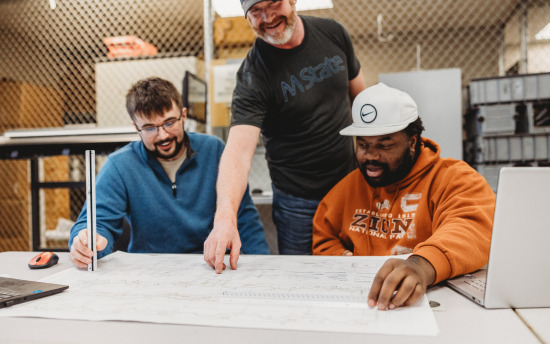 Photo of construction management students reviewing blueprints