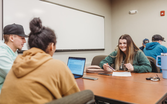 Photo of criminal justice students working on a group project in a classroom