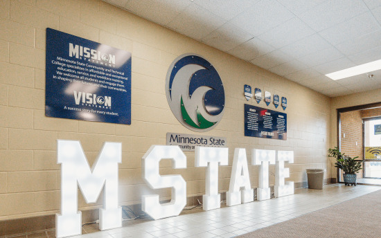 A hallway with many M State branded signs