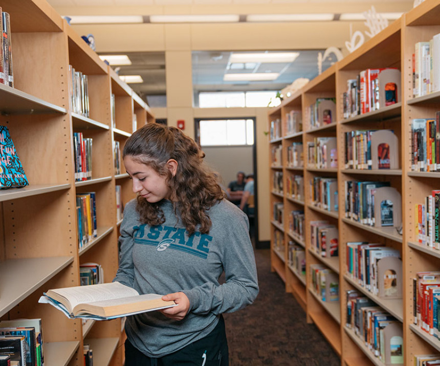 A student examines a book at the library