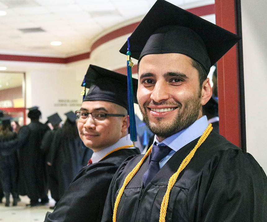 An M State student smiles at graduation