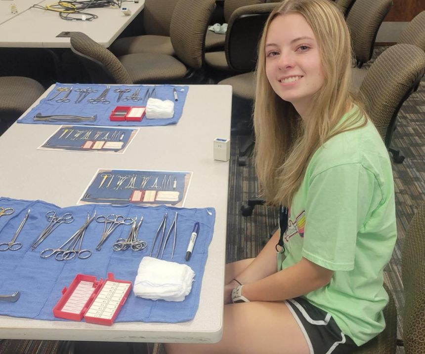 A Hope Camp participant sits at a table with medical equipment