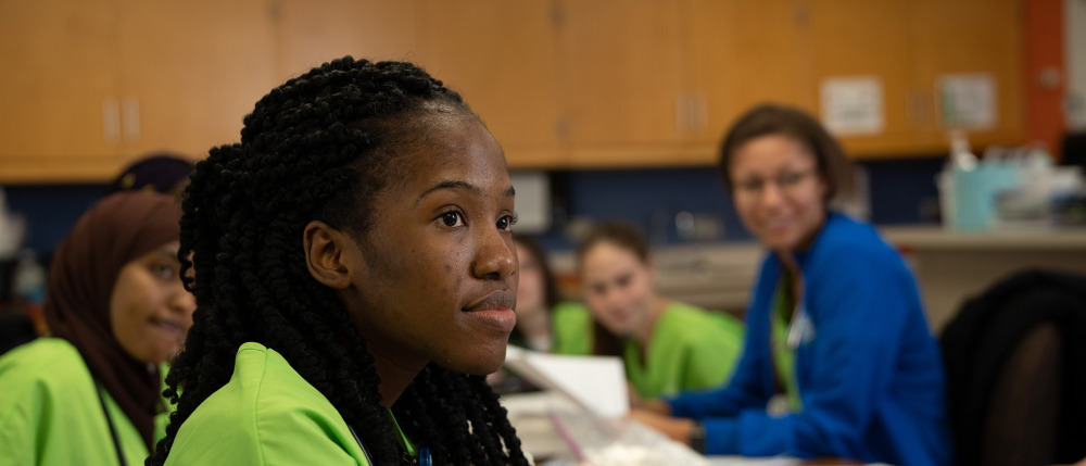 A student thoughtfully listens in class